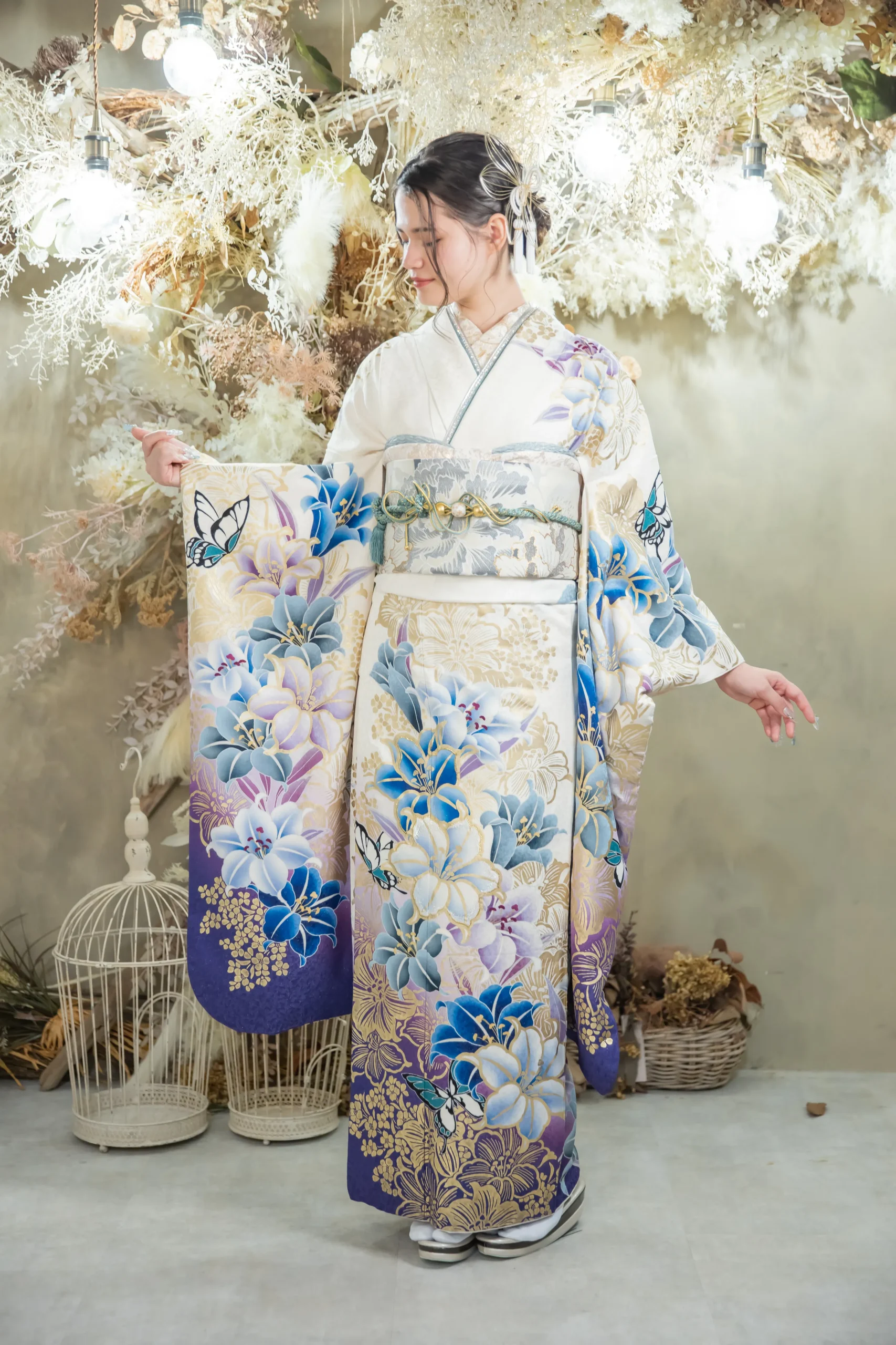 白地に青と紫の大輪花柄と蝶モチーフが華やかな古典モダン振袖を着用した女性の全身スタジオ写真。成人式振袖レンタルPLUM（プラム）岐阜・一宮対応